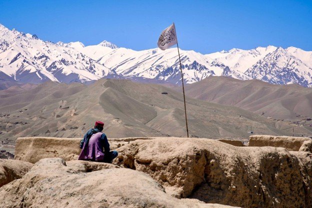 afghanistan mountain with taliban flag.jpg